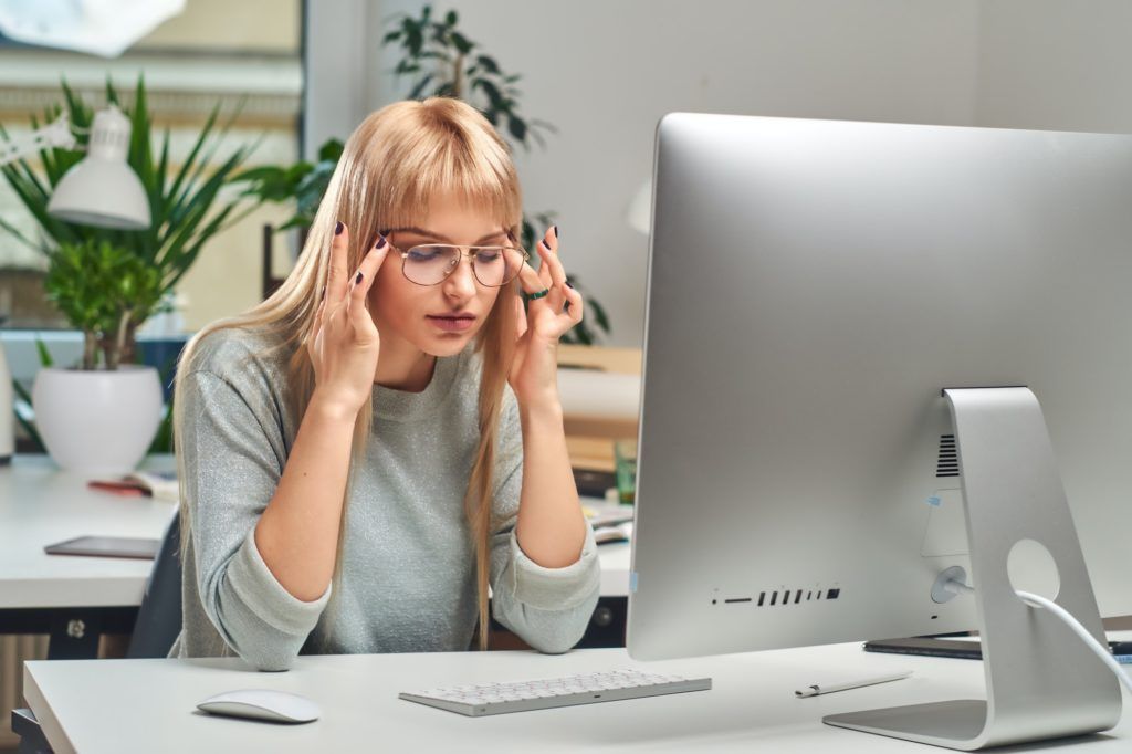 Woman feels tired while working in the office